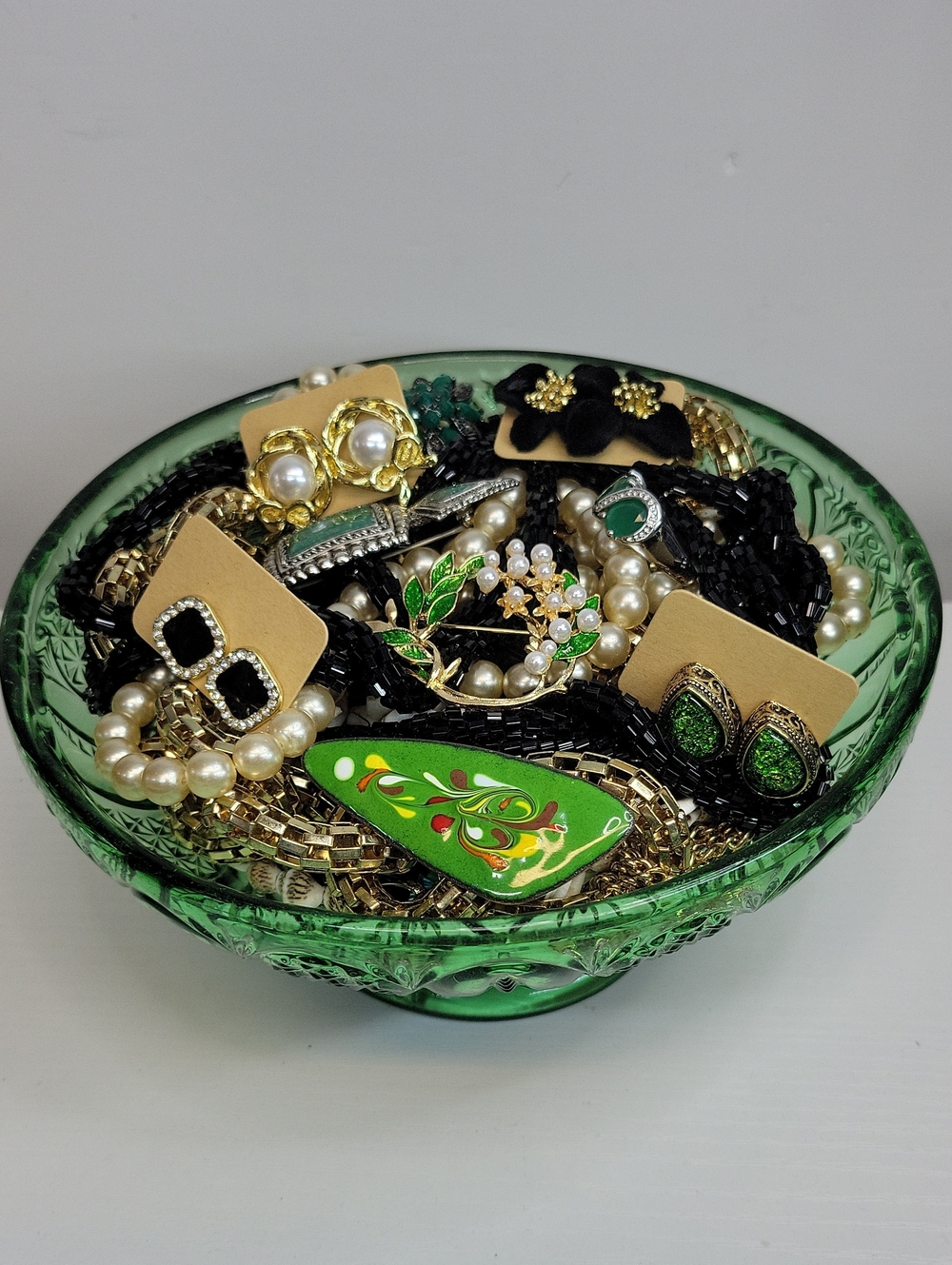 Assorted Jewelry in A Green Dish